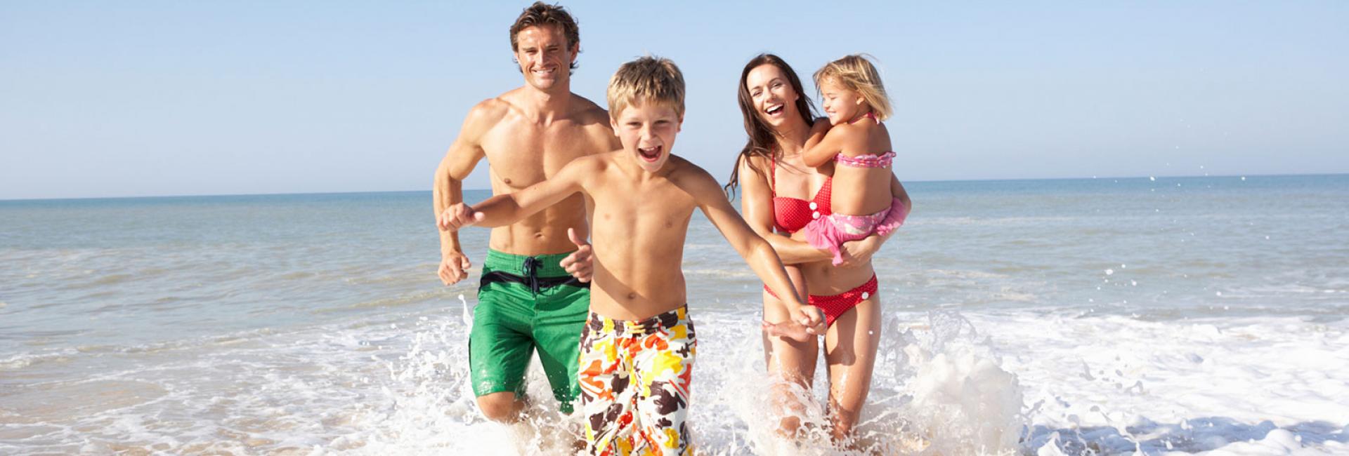 Family running on the beach
